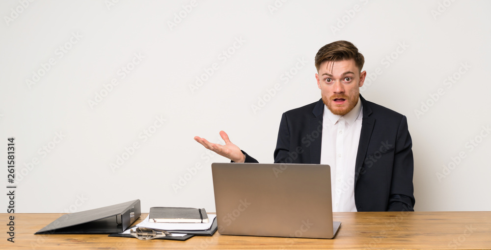 Businessman in a office making doubts gesture Businessman in a office making doubts gesture
