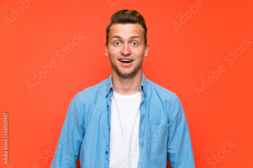 Blonde handsome man over isolated wall with surprise facial expression
