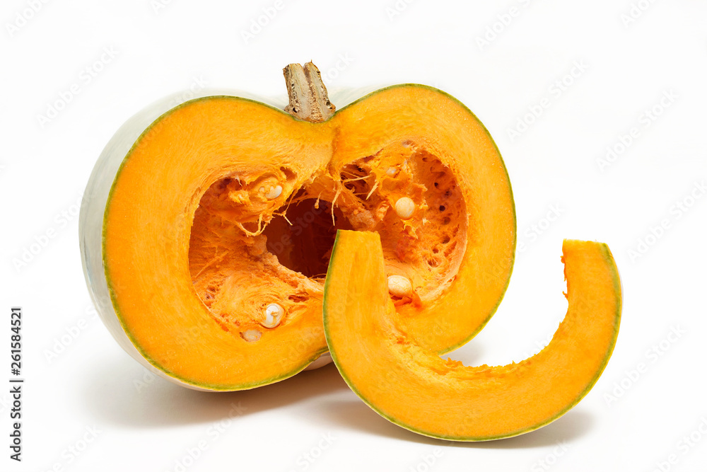 A group of one half and one slice of fresh pumpkin isolated on a white background. Close-up. A group of one half and one slice of fresh pumpkin isolated on a white background. Close-up.