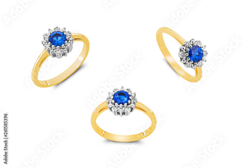 Gold rings with blue sapphires isolated on white background photo