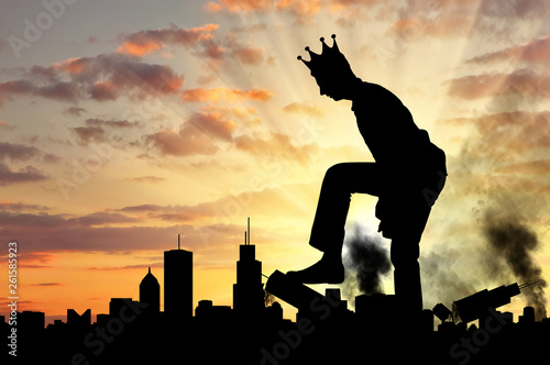 Big selfish man with a crown destroys the city on his way photo