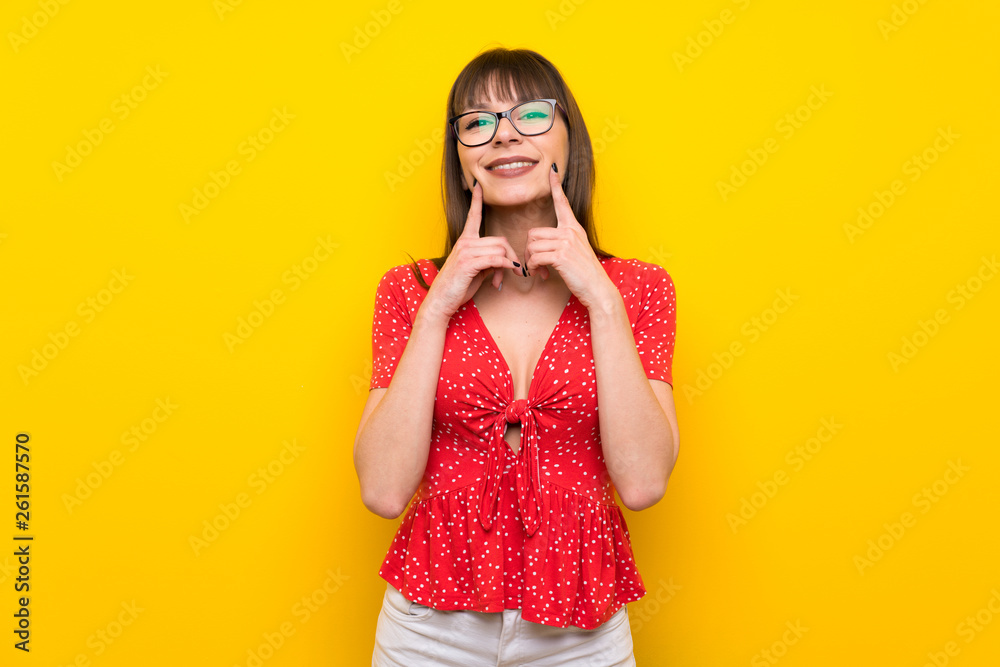 Young woman over yellow wall smiling with a happy and pleasant expression Young woman over yellow wall smiling with a happy and pleasant expression