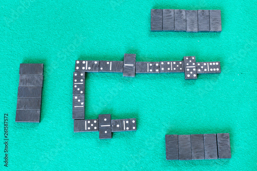 gameplay of dominoes board game with black tiles