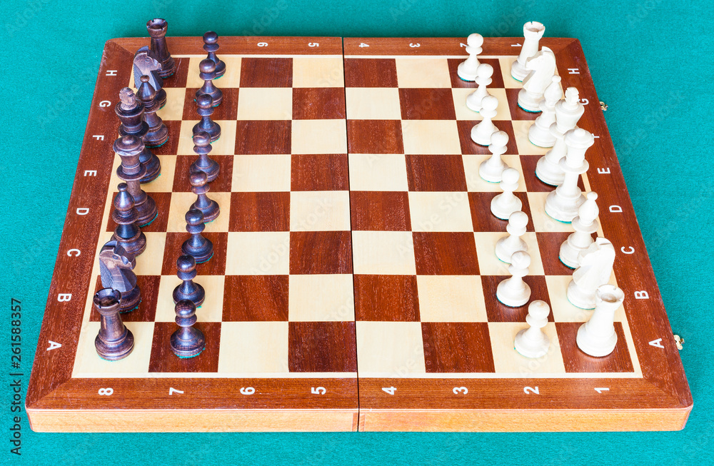 side view of wooden chessboard with chess pieces side view of wooden chessboard with chess pieces