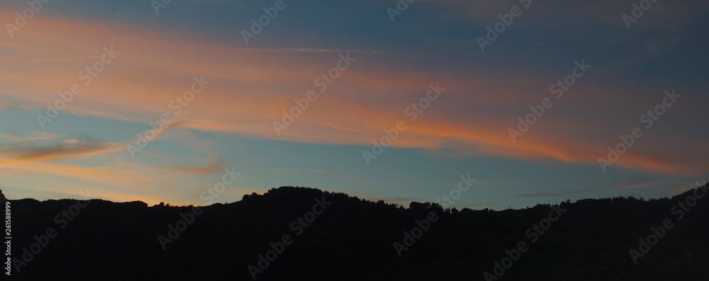 Mountain silhouette with cirrus clouds just after the blue hour