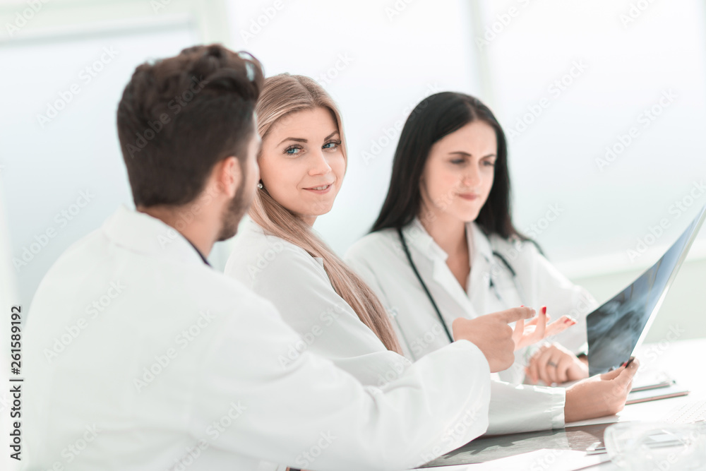 doctor radiologist discussing x-ray with her colleagues. doctor radiologist discussing x-ray with her colleagues.