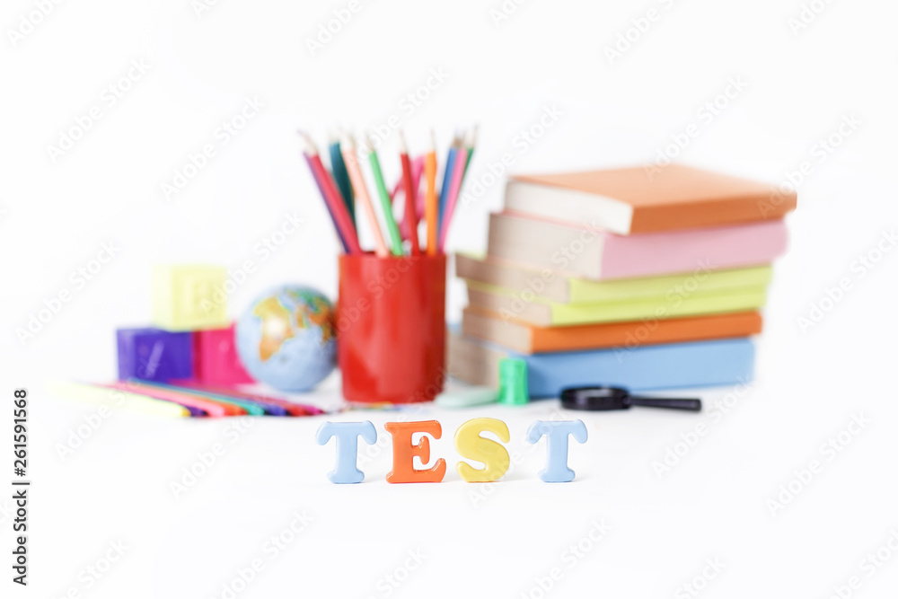 Fototapeta premium word test on the background of school supplies .photo with copy space