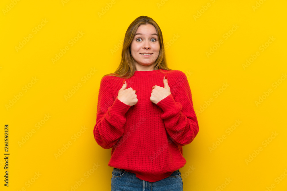 Young woman over yellow wall with surprise facial expression Young woman over yellow wall with surprise facial expression