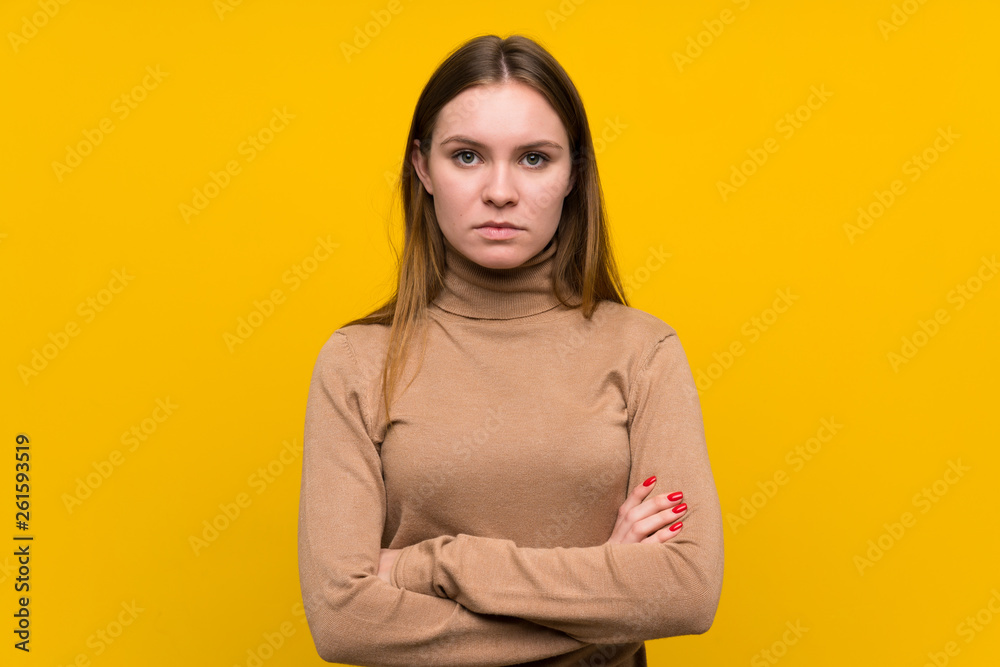 Fototapeta premium Young woman over colorful background keeping arms crossed