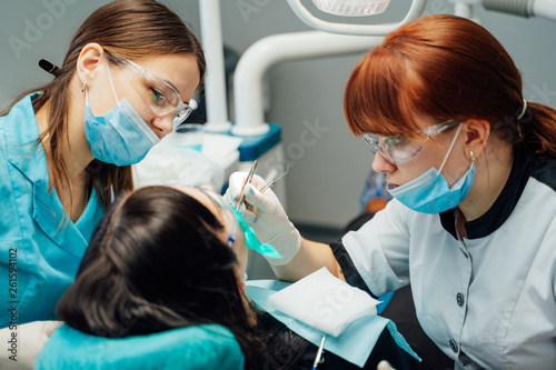 Dentist with assistant work in dental clinic