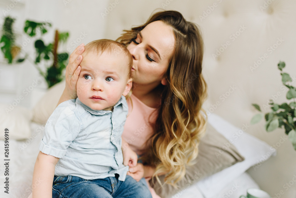 Beautiful young mother holding her cute son Beautiful young mother holding her cute son
