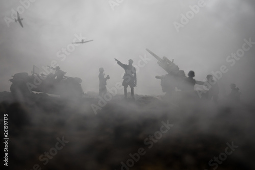 An anti-aircraft cannon and Military silhouettes fighting scene on war fog sky background. Allied air forces attacking on German positions. Artwork decorated scene. photo