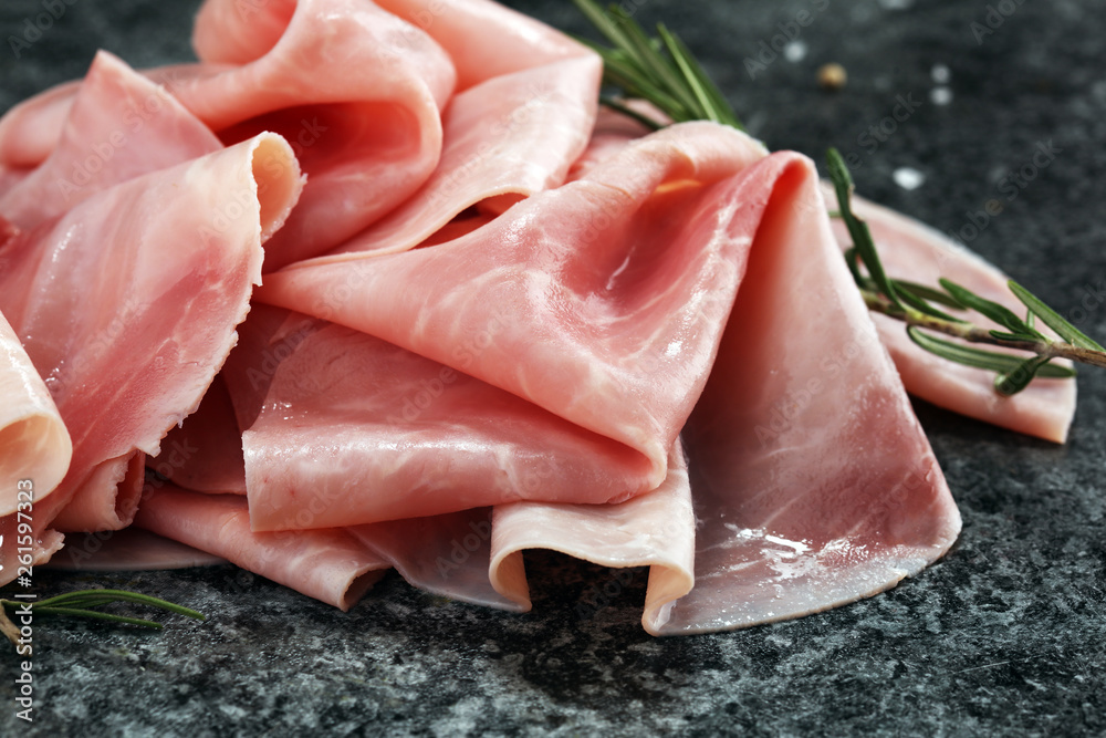 Sliced ham on wooden background. Fresh prosciutto cotto. Pork ham sliced.