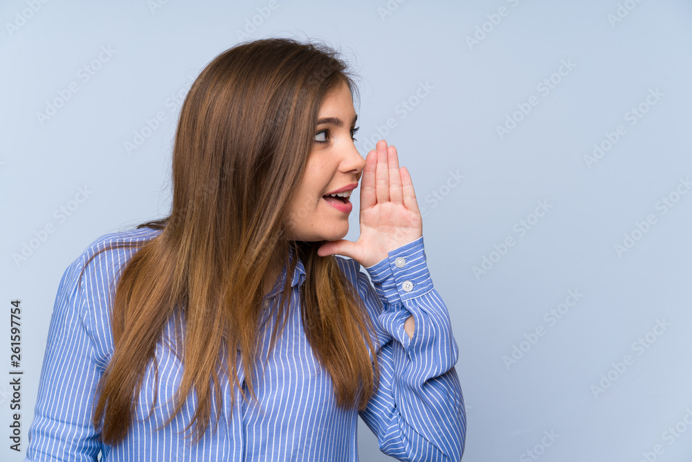 Young girl with striped shirt shouting with mouth wide open Young girl with striped shirt shouting with mouth wide open