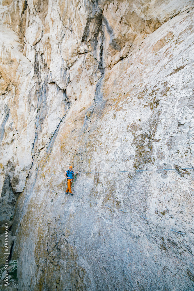 Fototapeta premium Man passing along via ferrata.