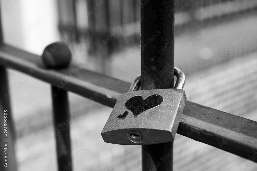 Black and white photo of padlock with heart on bridge, symbol of love Black and white photo of padlock with heart on bridge, symbol of love