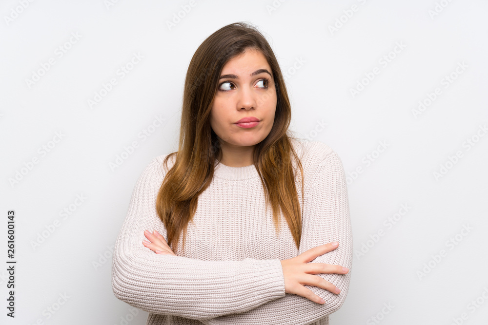 Young girl with white sweater standing and thinking an idea Young girl with white sweater standing and thinking an idea