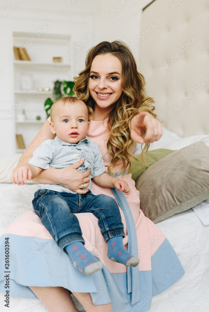 Beautiful young mother holding her cute son Beautiful young mother holding her cute son