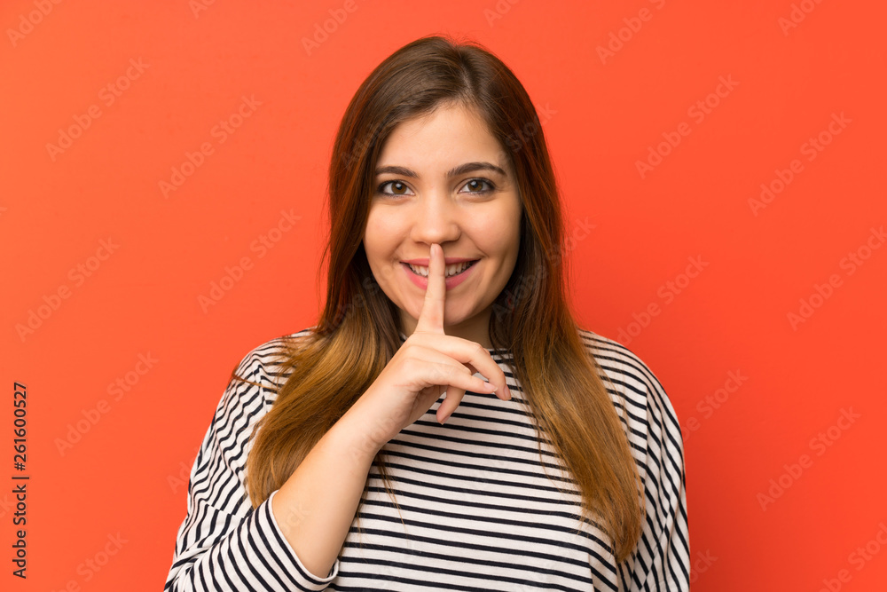 Young girl with striped shirt doing silence gesture Young girl with striped shirt doing silence gesture