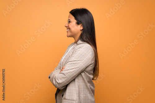 Young Colombian girl over brown wall in lateral position © luismolinero
