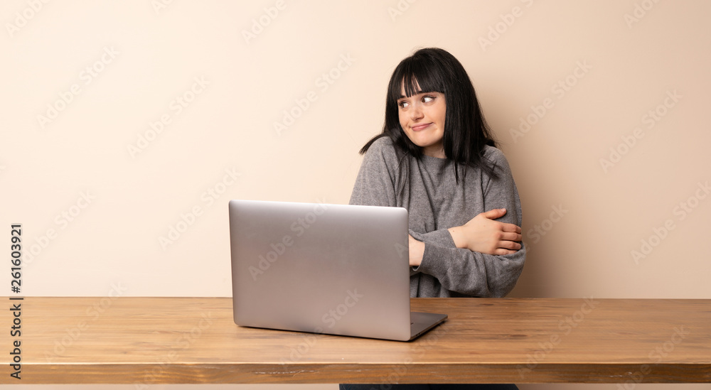 Young woman working with her laptop making doubts gesture while lifting the shoulders Young woman working with her laptop making doubts gesture while lifting the shoulders
