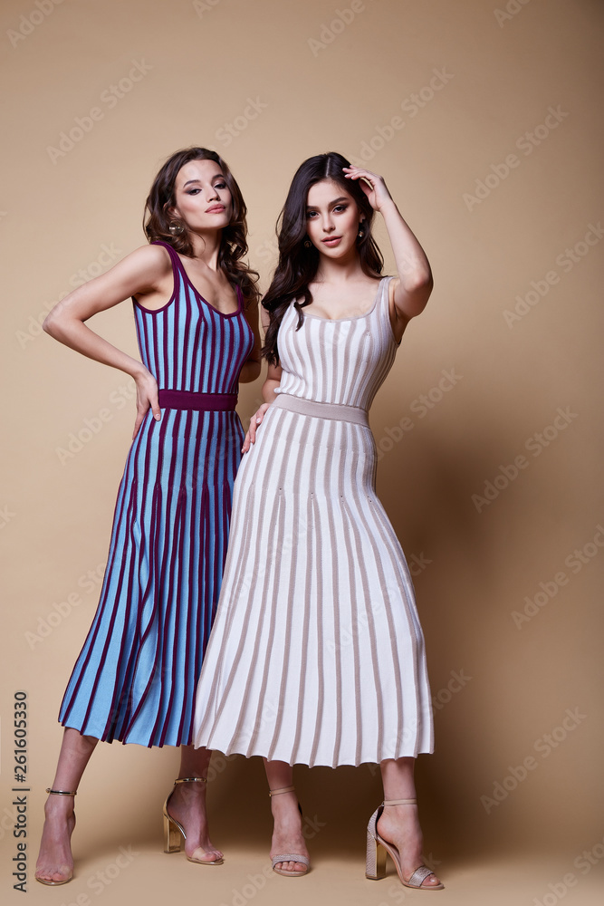 Two sexy beauty woman pretty face tan skin wear knitted blouse skirt long skinny body shape makeup cosmetic dress code collection studio catalog brunette curly hair clothes date office party fashion. Two sexy beauty woman pretty face tan skin wear knitted blouse skirt long skinny body shape makeup cosmetic dress code collection studio catalog brunette curly hair clothes date office party fashion.