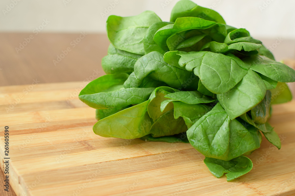 green spinach on a table on a wooden board