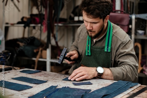 A master works with genuine leather making exclusive things