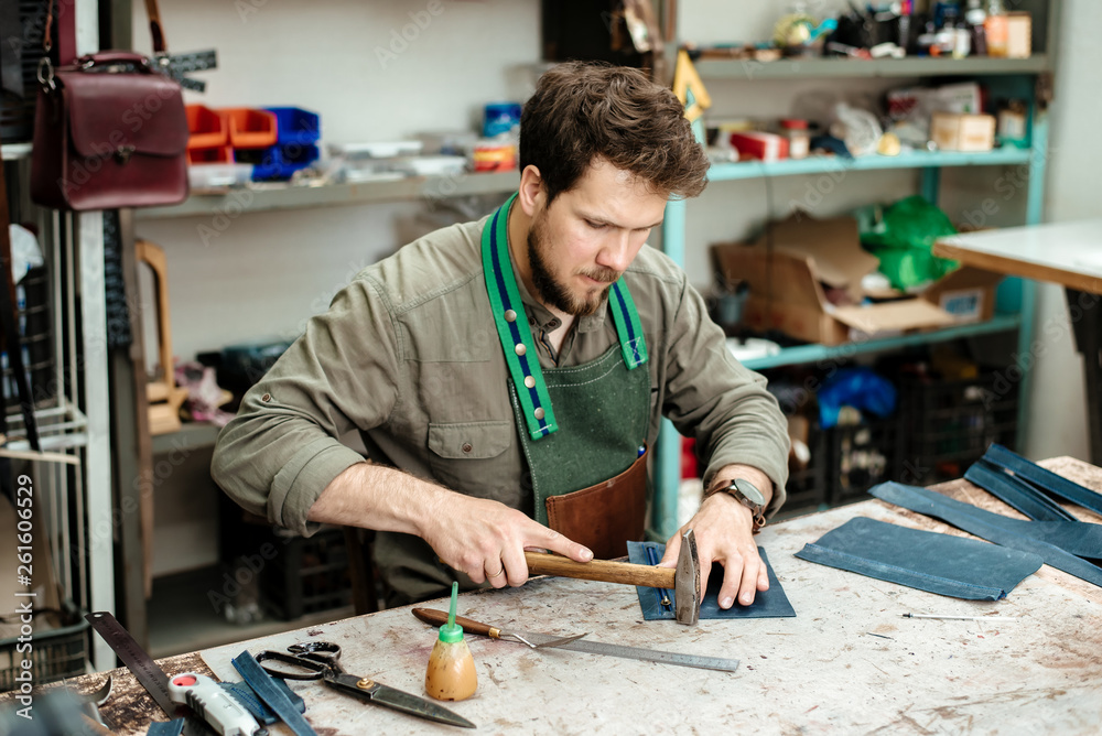A master works with genuine leather making exclusive things A master works with genuine leather making exclusive things