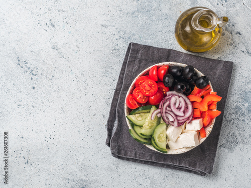 Greek Salad Bowl on gray cement background, copy space. Above view of Bowl Greek Salad. Trendy food. Idea, recept and concept of modern healthy food. photo