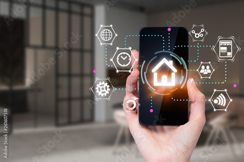 Woman hand with phone, smart home concept photo