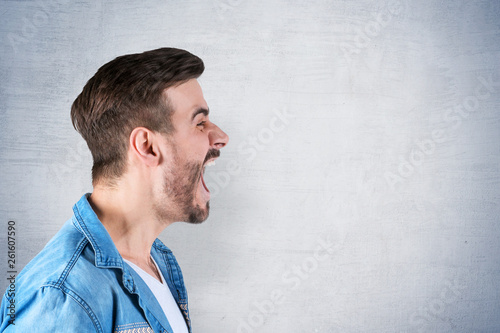 Side view of young man screaming