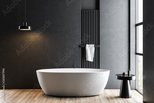 Fototapeta Dark gray bathroom with white tub