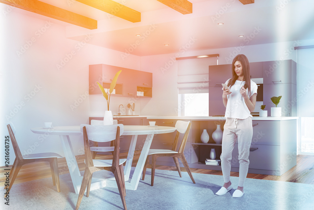 Young girl in white kitchen with table Young girl in white kitchen with table