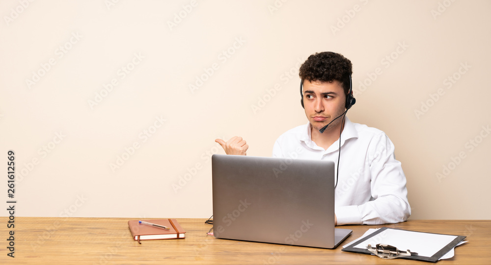Telemarketer man unhappy and pointing to the side Telemarketer man unhappy and pointing to the side