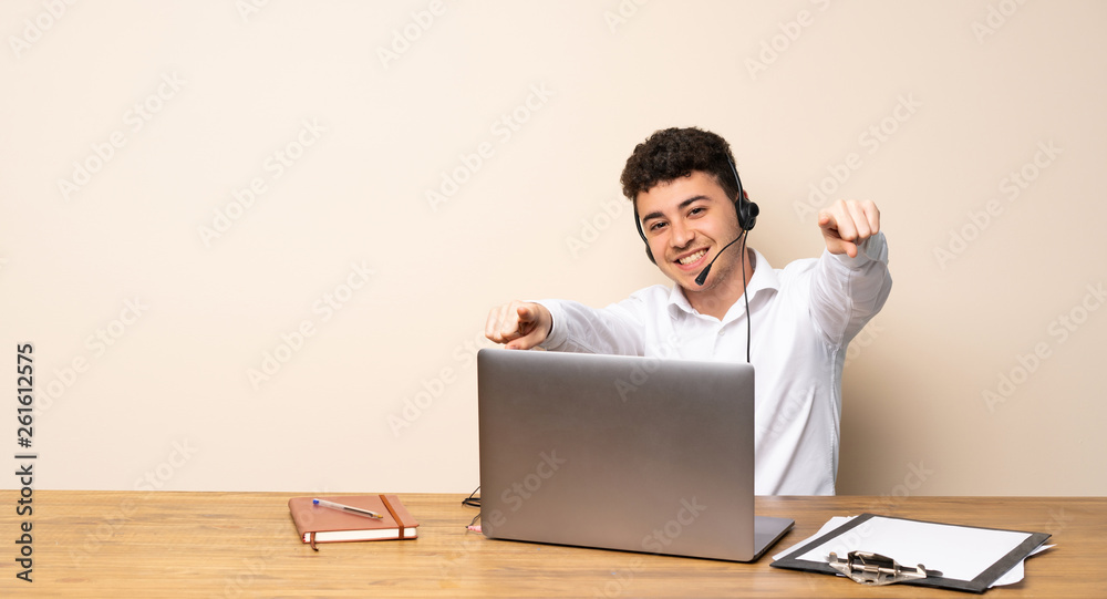 Telemarketer man points finger at you while smiling Telemarketer man points finger at you while smiling