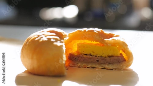 up and down shot with morning sunlight sausage egg open kolache. Sausage, egg, and cheese kolache in the sunlight. photo