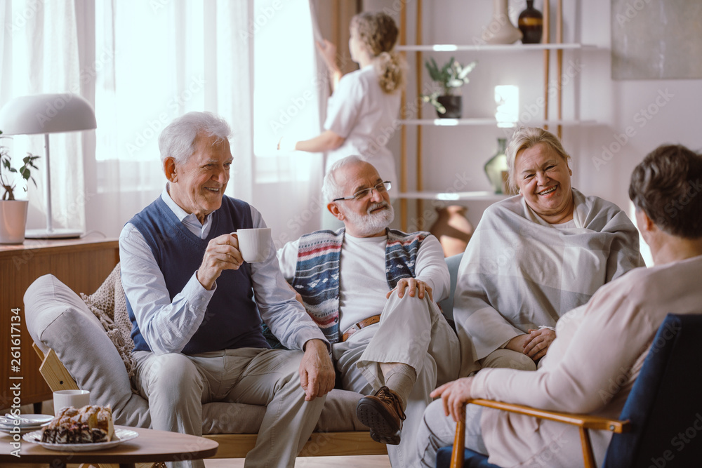 Smiling elderly people talking together in nursing home Stock Photo | Adobe Stock