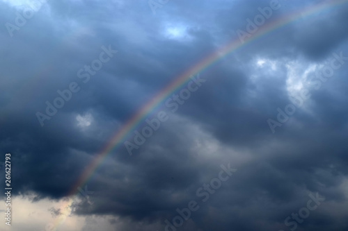 Beautiful rainbow with clouds and rain . Spring warmth © iaroslav_brylov