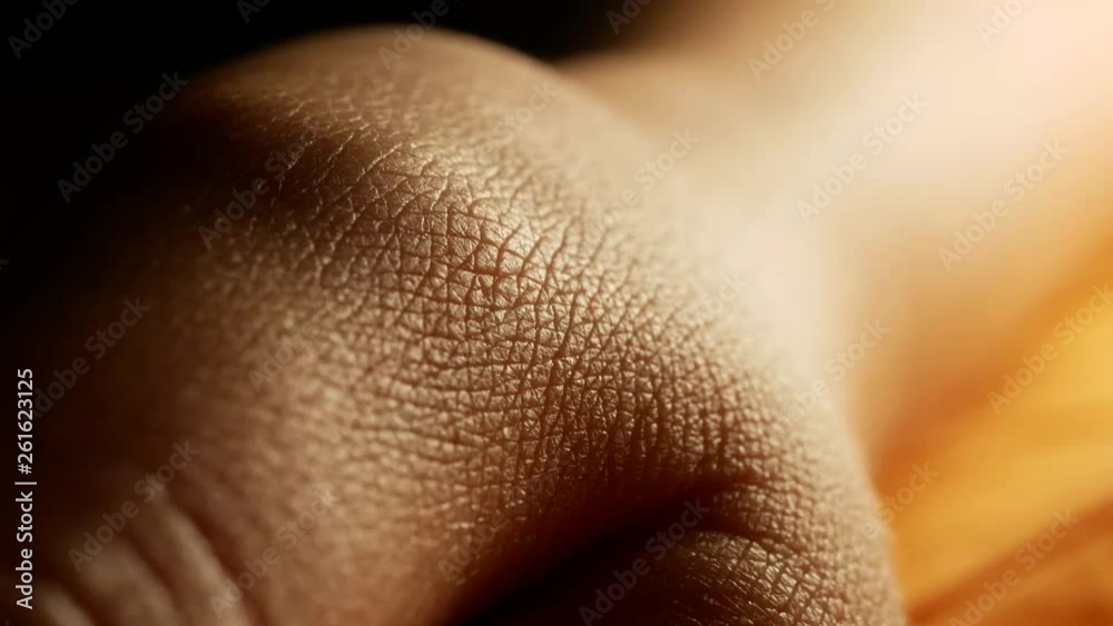 Extreme macro of skin texture on hand around thumb, high contrast backlight, focus moves from far to close focus, hairless skin of asian female in mid 20's Extreme macro of skin texture on hand around thumb, high contrast backlight, focus moves from far to close focus, hairless skin of asian female in mid 20's