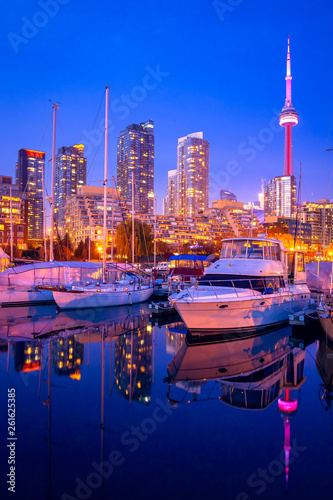 Blue hour at Toronto harbor with CN tower and high rise buildings as background