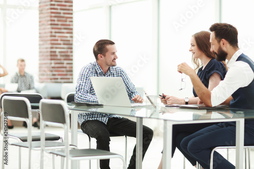 business team discussing something sitting at the office table