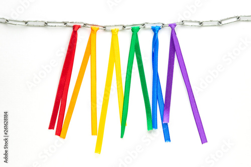 LGBT pride flag, built of colored ribbons tied on an iron chain, short focus, on a white background