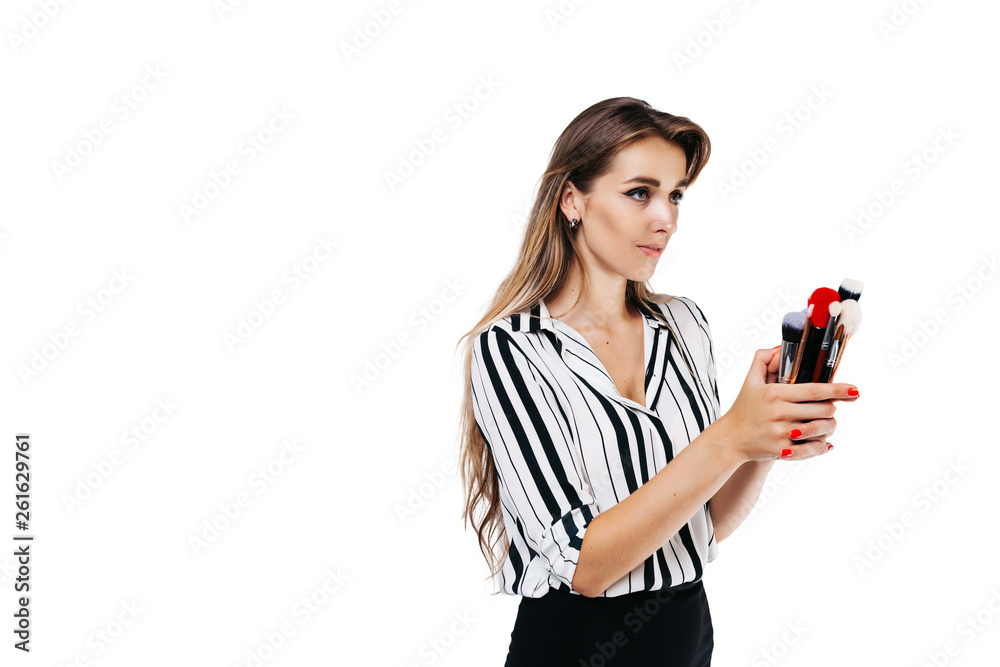 make-up artist girl on a white background holding a white brush and one large red make-up artist girl on a white background holding a white brush and one large red