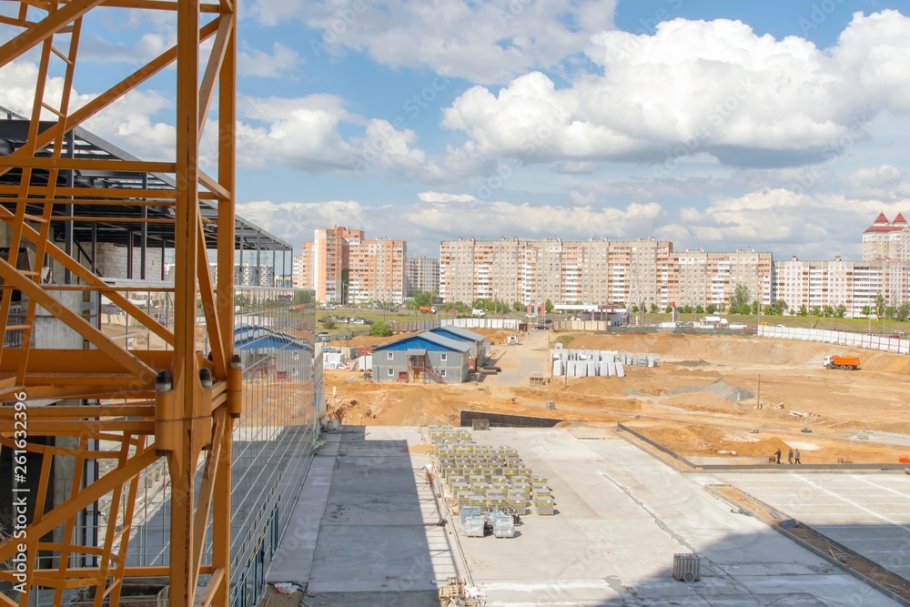 construction site, machinery, building materials, against the backdrop of the cityscape