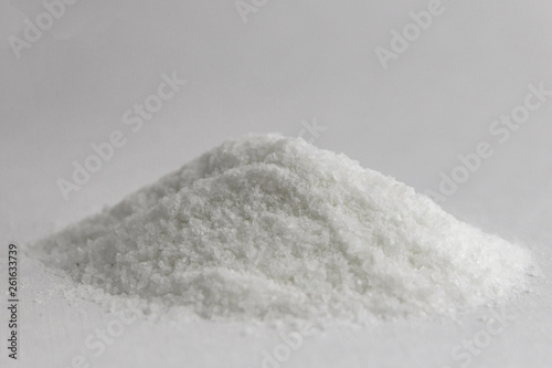 mineral diet: a small pile of sea iodized edible salt on a plate, short focus