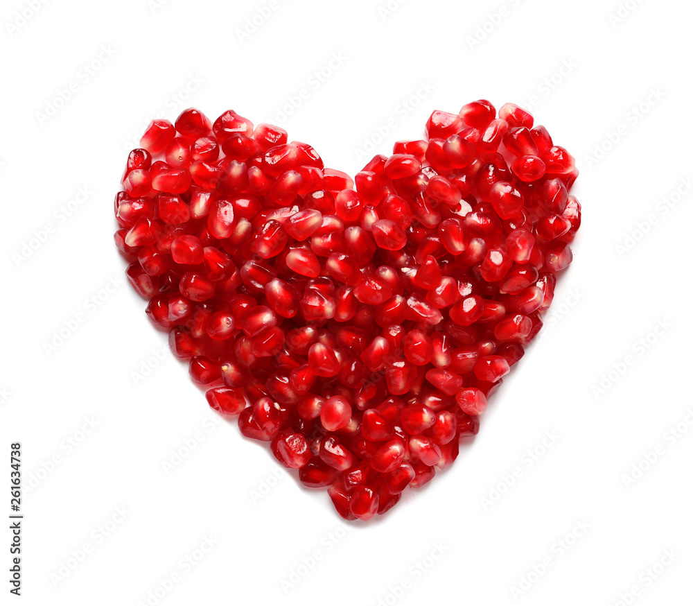 Heart made of pomegranate seeds on white background, top view. Healthy diet Heart made of pomegranate seeds on white background, top view. Healthy diet