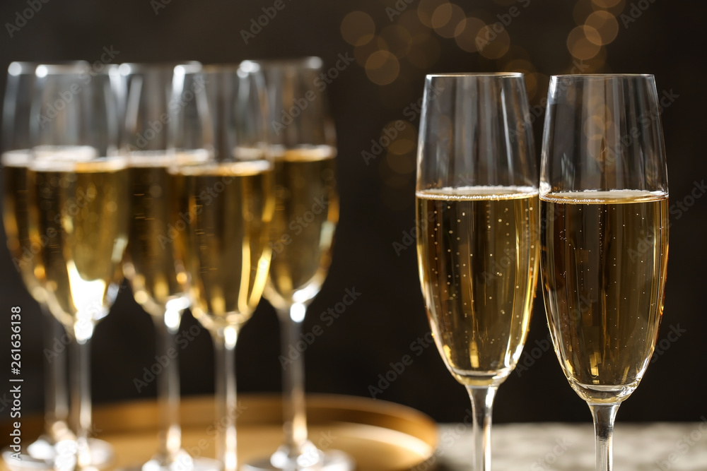 Glasses of champagne on blurred background, closeup. Space for text Glasses of champagne on blurred background, closeup. Space for text