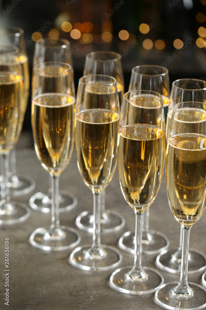 Glasses of champagne on table against blurred background Glasses of champagne on table against blurred background