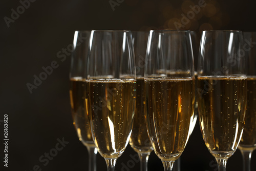 Glasses of champagne on dark background, closeup